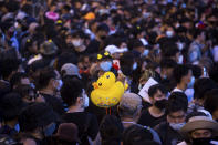 Inflatable yellow ducks, which have become a good-humored symbol of resistance during anti-government rallies, are held by a protester during a rally Wednesday, Nov. 25, 2020 in Bangkok, Thailand. Pro-democracy demonstrators in Thailand on Wednesday again took to the streets of the capital, even as the government escalated its legal battle against them, reviving the use of a harsh law against defaming the monarchy. (AP Photo/Wason Wanichakorn)