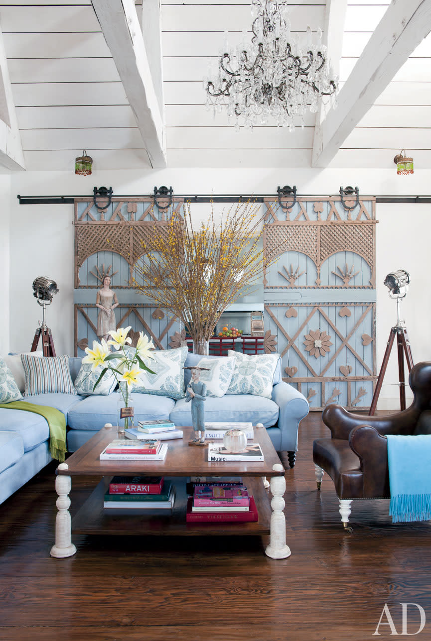 The living room, painted in Benjamin Mooreâ€™s Antique White, showcases Sharonâ€™s Italian puppets and dolls.