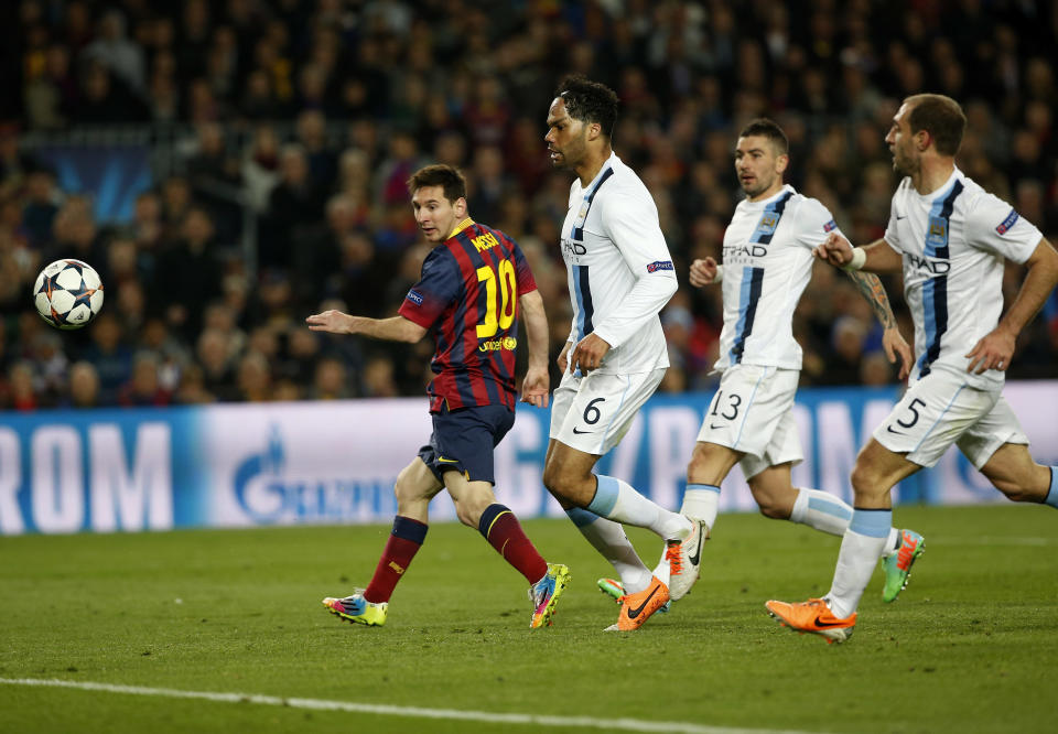 Barcelona's Lionel Messi, left scores during a Champions League, round of 16, second leg, soccer match between FC Barcelona and Manchester City at the Camp Nou Stadium in Barcelona, Spain, Wednesday March 12, 2014. (AP Photo/Emilio Morenatti)