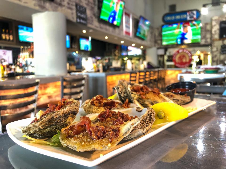 Pelican Larry's Raw Bar and Grill's "Casino," Freshly shucked clams or oysters topped with garlic and herb breadcrumbs, butter and bacon. Baked until golden and served with fresh lemon. Pictured is oysters (6) $14.95.