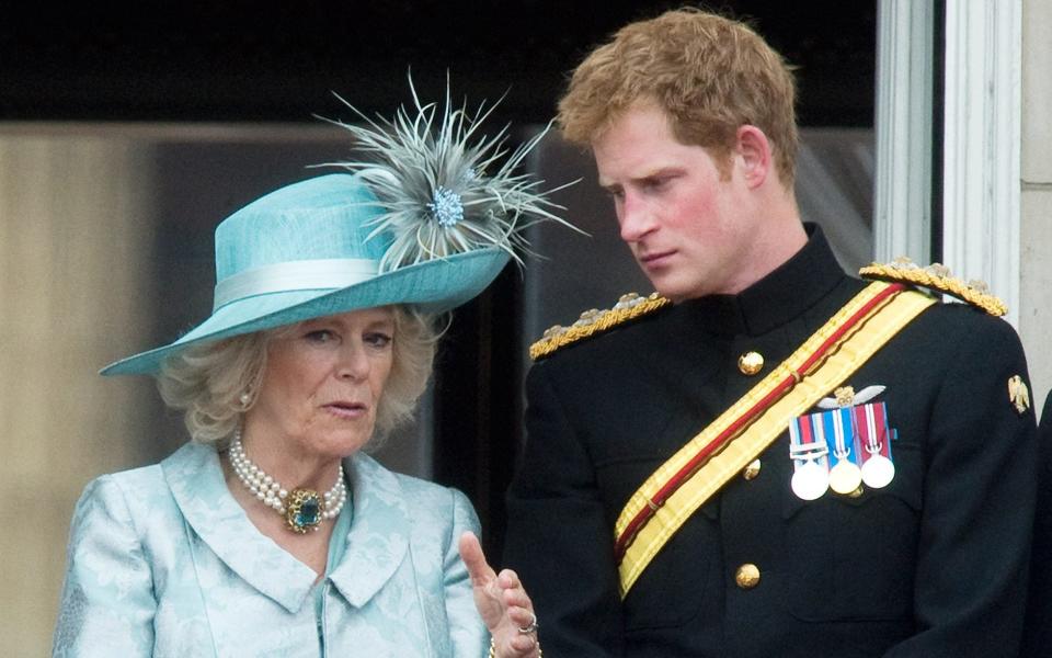 Camilla, the Queen Consort, and Prince Harry stand on the balcony of Buckingham Palace following the Trooping the Colour Ceremony on June 16, 2012 - Anwar Hussein/WireImage