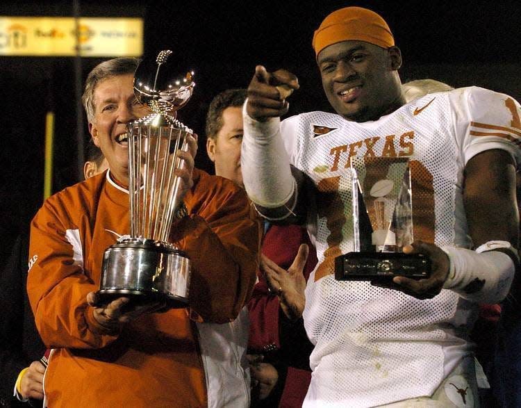Texas coach Mack Brown and quarterback Vince Young celebrate their win over USC in the 2005 national championship game at the Rose Bowl. USC's Reggie Bush may have won that year's Heisman Trophy over Young, but it was Young who laughed last.