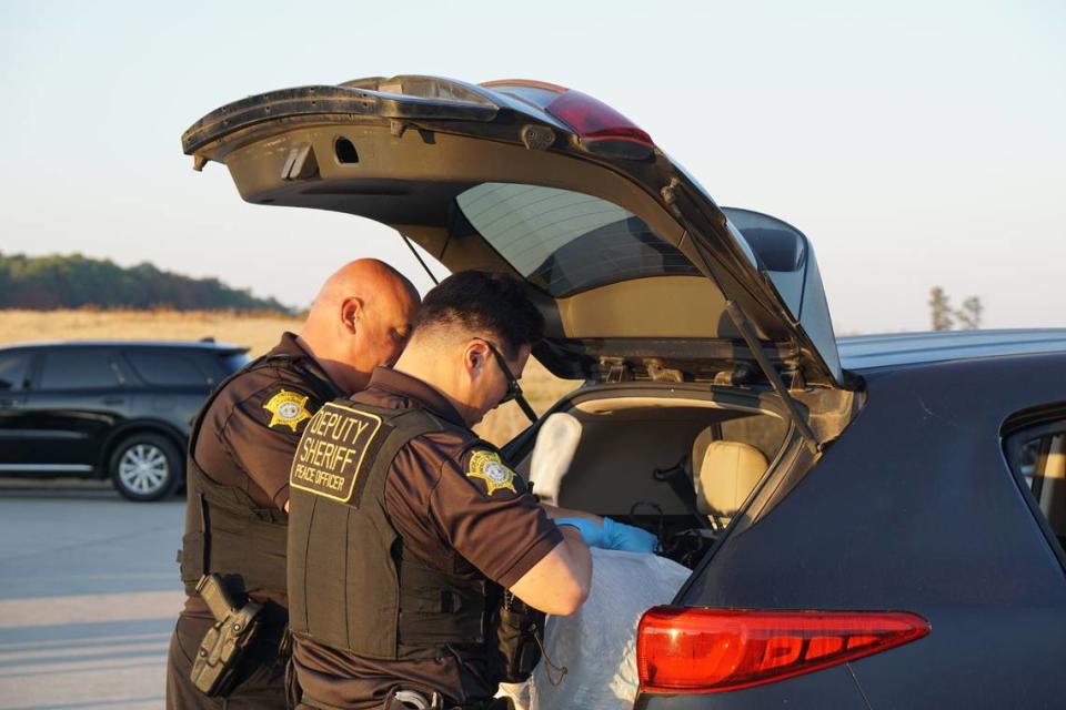 Richland County Sheriff’s Deputies hand search a car belonging to a Dept. of Corrections staff member that has been flagged by a K-9 during a sting operation. Ted Clifford