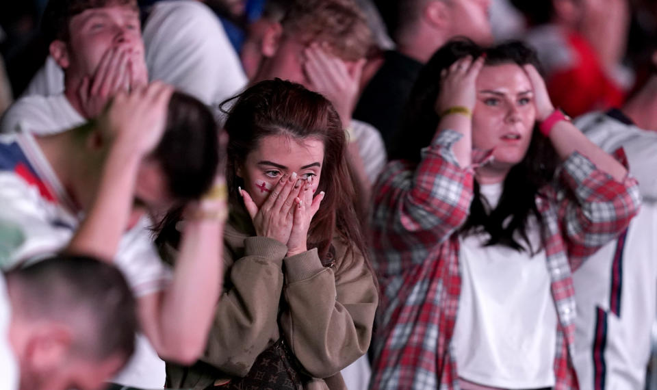 England fans are dejected after England lose the game on penalties at the fan zone in Trafford Park, Manchester as they watch the UEFA Euro 2020 Final between Italy and England. Picture date: Sunday July 11, 2021.