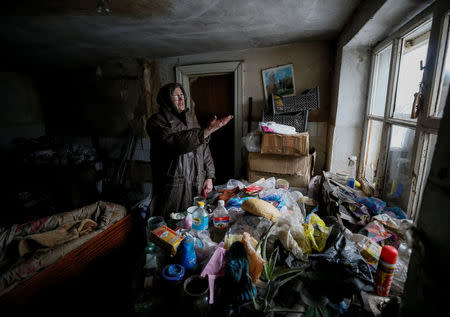 A local resident is seen in her home which was damaged during fighting between the Ukrainian army and pro-Russian separatists in the government-held industrial town of Avdiyivka, Ukraine, February 6, 2017. REUTERS/Gleb Garanich