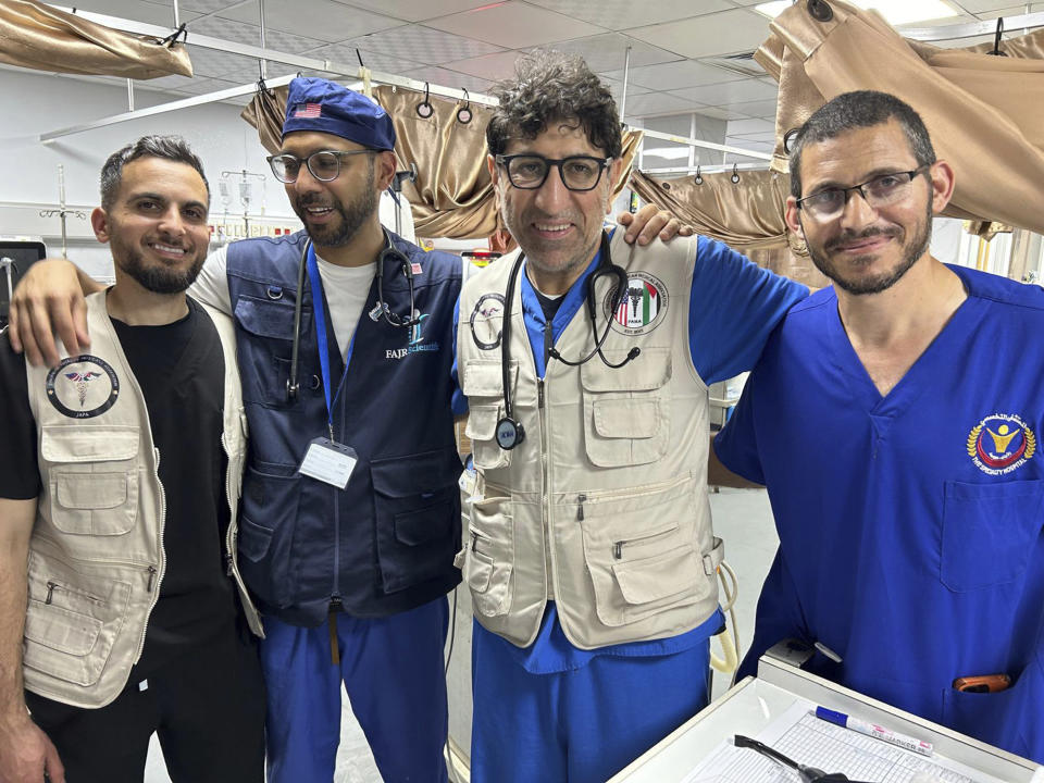 Dr. Ammar Ghanem, an ICU specialist from Detroit volunteering with the Syrian American Medical Society at one of Gaza's last functioning hospitals, second from right, poses on May 7, 2024, in Khan Younis, Gaza, with a Palestinian doctor and two other American doctors volunteering at the European General Hospital where they have been since early May. A group of 35 foreign doctors on a volunteer mission to help at the hospital, including 22 Americans, have been trapped in Gaza by Israel’s seizure of the Rafah crossing into Egypt.