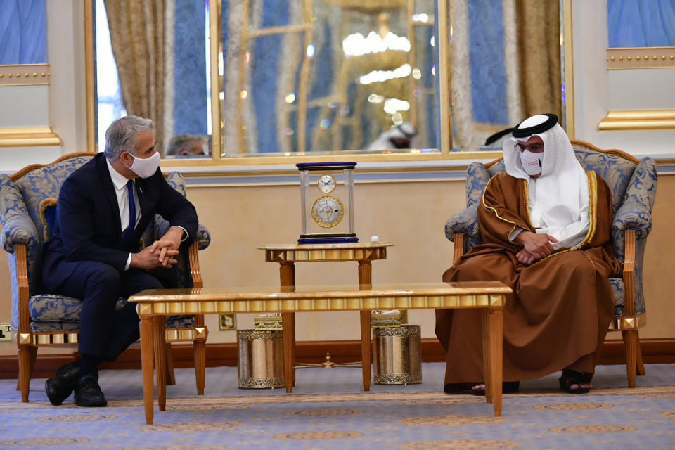 In this photo provided by the Israeli Government Press Office, Israel's Foreign Minister Yair Lapid, left, meet with Bahrain's Crown Prince Salman bin Hamad Al Khalifa, during the first high-level visit to the small Gulf state by a senior Israeli official since the signing of a landmark agreement to establish diplomatic ties between the two countries last year, in Manama, Bahrain, Thursday, Sept. 30, 2021. Lapid will inaugurate Israel’s embassy. (Shlomi Amshalem/GPO via AP)