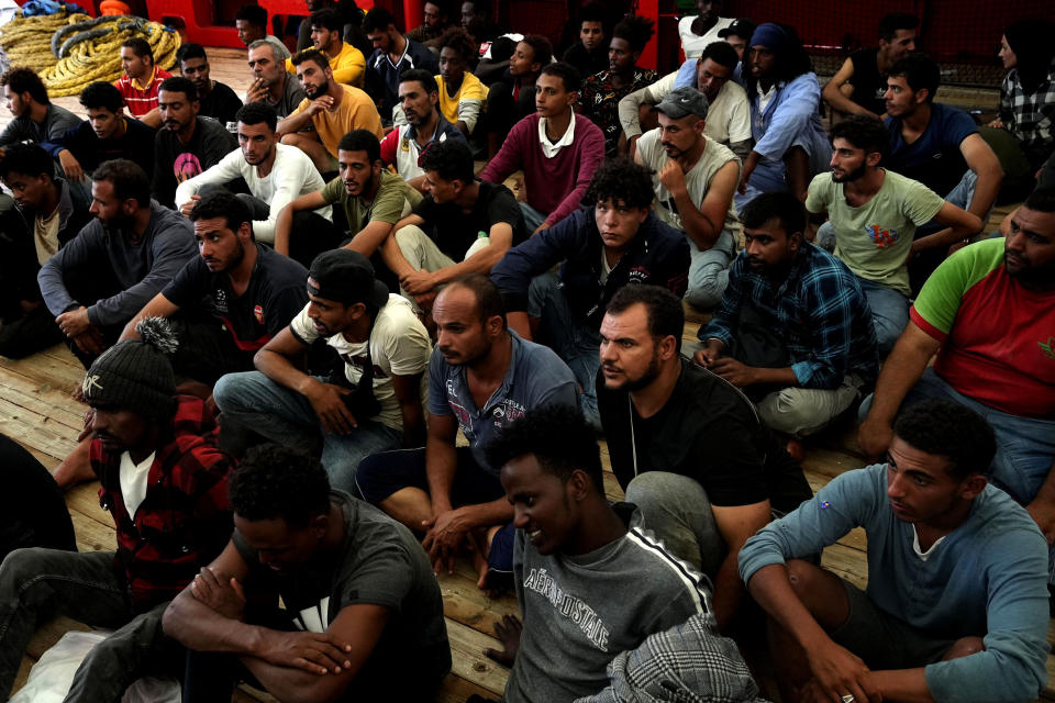 Migrants sit on the deck after being rescued by the Spanish NGO Open Arms lifeguards during a rescue operation in the international waters zone near Tunisia, Mediterranean sea, Saturday, Sept. 17, 2022. Fifty-nine migrants from Syria, Egypt, Sudan and Eritrea, 10 of them minors, were rescued by NGO Open Arms crew members. (AP Photo/Petros Karadjias)