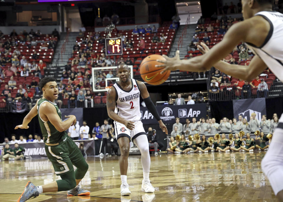 Colorado State's John Tonje, left, reacts as San Diego State's Micah Parrish, right, receives a pass from Adam Seiko (2) during the second half of an NCAA college basketball game in the quarterfinals of the Mountain West Conference Tournament Thursday, March 9, 2023, in Las Vegas. San Diego State won 64-61. (AP Photo/Ronda Churchill)