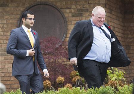 Toronto Mayor Rob Ford leaves his mother's house with Deputy Chief of Staff Sunny Petrujkic (L) in Toronto, November 1, 2013. REUTERS/Mark Blinch