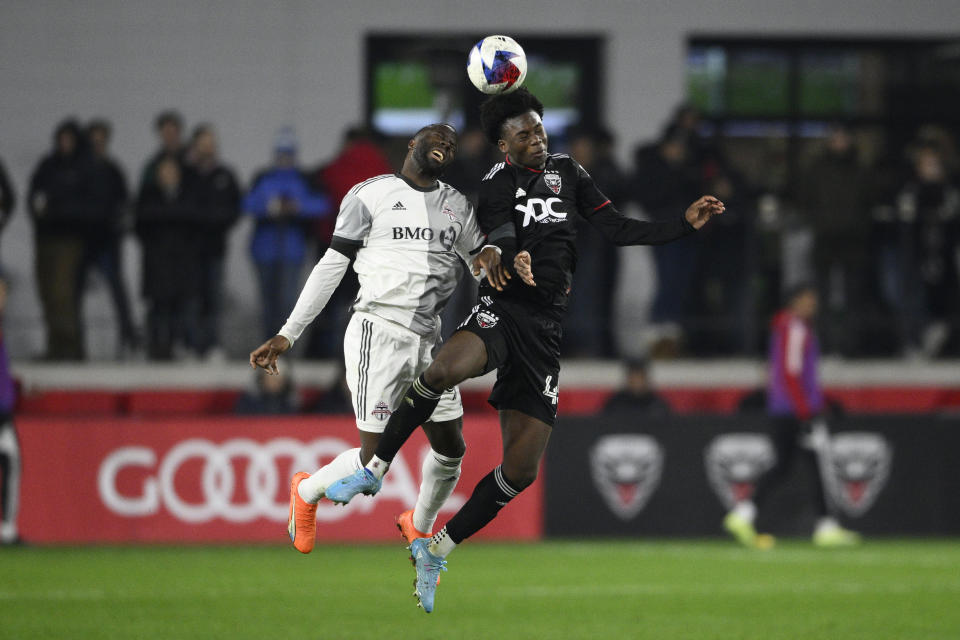 D.C. United defender Matai Akinmboni, right, heads the ball in front of Toronto FC forward Adama Diomande, left, during the second half of an MLS soccer match, Saturday, Feb. 25, 2023, in Washington. (AP Photo/Nick Wass)