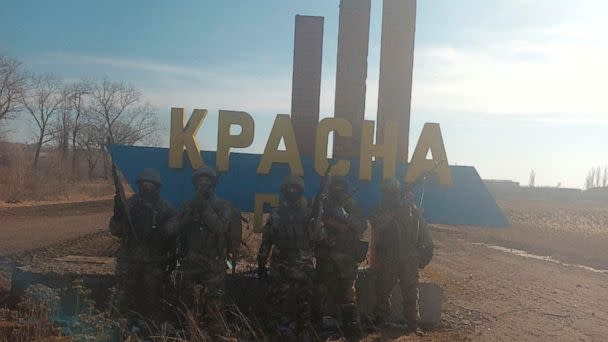 PHOTO: An image, released by founder of Russia's Wagner Group Yevgeny Prigozhin's press service, shows what it said to be Wagner fighters posing for a picture at the entrance sign to the village of Krasna Hora near the embattled city of Bakhmut, Ukraine. (Concord Press Service/via Reuters)