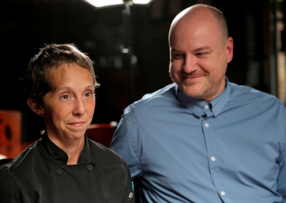 Chef Rachel Foster talks Thursday about her injuries with husband, John, at Moni's Pasta and Pizza.