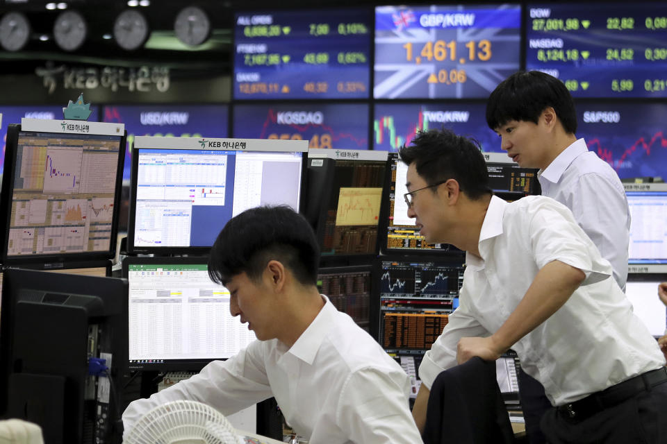 Currency traders watch monitors at the foreign exchange dealing room of the KEB Hana Bank headquarters in Seoul, South Korea, Thursday, Oct. 17, 2019. Asian shares were mixed Thursday after officials signaled work remains to be done on an agreement for a truce in the tariff war between the U.S. and China. (AP Photo/Ahn Young-joon)