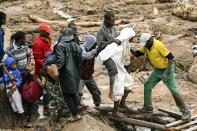 FILE - An injured man is carried in Blantyre, Malawi, Monday, March 13, 2023, in the aftermath of Cyclone Freddy. This year’s COP28 in Dubai is likely to see more discussion about compensation for developing nations harmed by climate change. (AP Photo/Thoko Chikondi, File)