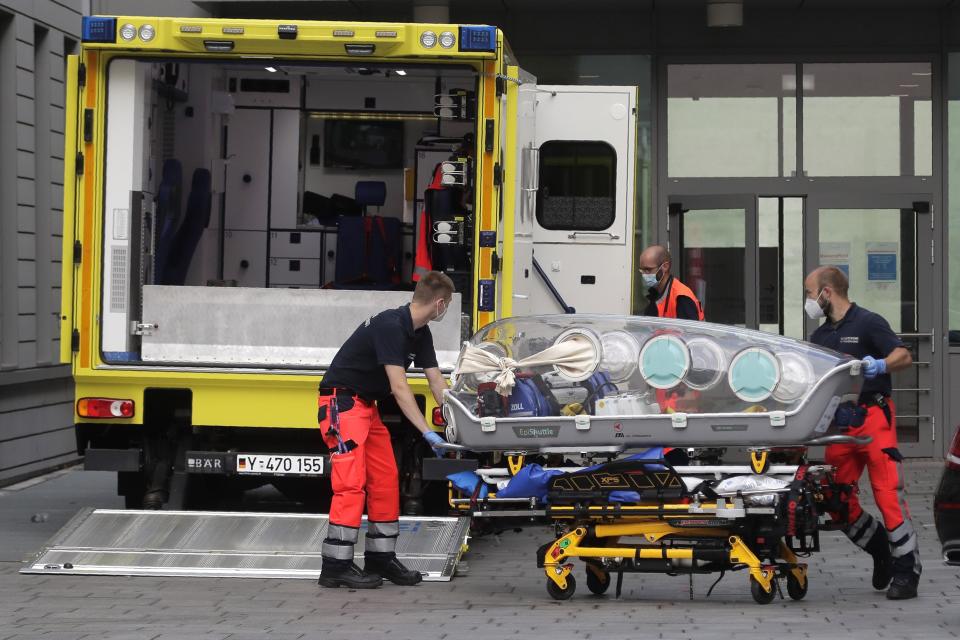 FILE - An empty stretcher is carried back into an ambulance which is believed to have transported Alexei Navalny at the emergency entrance of the Charite hospital in Berlin, Germany, on Aug. 22, 2020. Navalny, Putin's most prominent foe, falls severely ill while organizing political opposition to Putin in Siberia and is later flown to Germany, where he is diagnosed with nerve-agent poisoning. Navalny blames the attack on the Kremlin, which denies it. (AP Photo/Markus Schreiber, File)