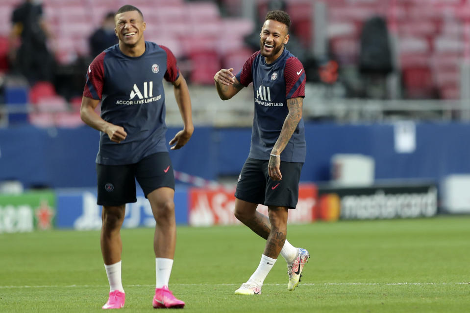 PSG's Neymar jokes with Kylian Mbappe, left, during a training session at the Luz stadium in Lisbon, Saturday Aug. 22, 2020. PSG will play Bayern Munich in the Champions League final soccer match on Sunday. (Miguel A. Lopes/Pool via AP)