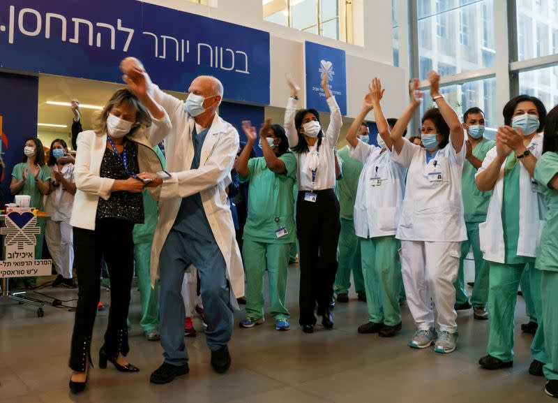 FILE PHOTO: Medical teams celebrate before receiving coronavirus disease (COVID-19) vaccines as Israel kicks off a coronavirus vaccination drive, at Tel Aviv Sourasky Medical Center (Ichilov Hospital) in Tel Aviv