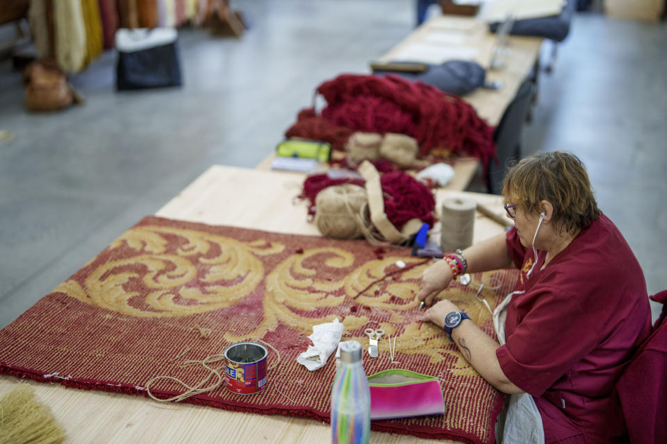 A craftswoman weaves a tapestry at the Royal Tapestry Factory in Madrid, Spain, Friday, Nov. 30, 2023. Since its foundation in 1721, the Royal Tapestry Factory of Madrid has not stopped producing. It was Philip V, then King of Spain, who had the factory built with the help of Catholic craftsmen from Flanders to replace the lack of private initiative that existed at the time. (AP Photo/Manu Fernandez)