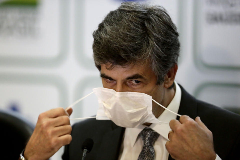 Brazil's outgoing Health Minister Nelson Teich removes his mask to give a news conference at the Health Ministry in Brasilia, Brazil, Friday, May 15, 2020. Teich resigned on Friday after less than a month on the job in a sign of continuing upheaval in the nation’s battle with the COVID-19 pandemic and President Jair Bolsonaro’s pressure for the nation to prioritize the economy over health-driven lockdowns. (AP Photo/Eraldo Peres)