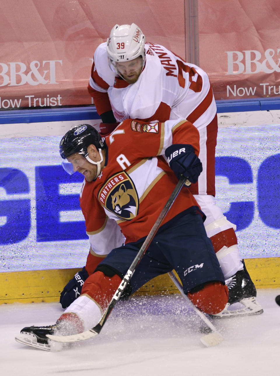 Detroit Red Wings right wing Anthony Mantha (39) gets tied up with Florida Panthers right wing Patric Hornqvist (70) during the first period of an NHL hockey game Tuesday, Feb. 9, 2021, in Sunrise, Fla. (AP Photo/Jim Rassol)