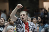 A protester chants by the Atlanta City Hall atrium as they line up to enter the chamber. The city council is voting on a funding package for the proposed public safety training center on Monday, June 5, 2023. (Miguel Martinez/Atlanta Journal-Constitution via AP)