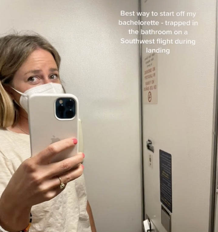 Harris Googe taking a selfie in the mirror in the plane's toilet after getting stuck.