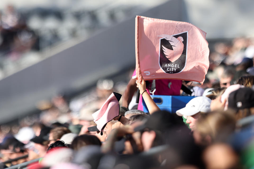 LOS ANGELES, CALIFORNIA - MARCH 17: A fan waves an Angel City FC flag during a game between Angel City FC and Bay FC at BMO Stadium on March 17, 2024 in Los Angeles, California. (Photo by Katharine Lotze/Getty Images)