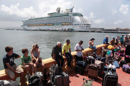 People line up to board a Royal Caribbean cruise ship that will take them to the U.S. mainland, in San Juan, Puerto Rico, September 28, 2017. REUTERS/Alvin Baez
