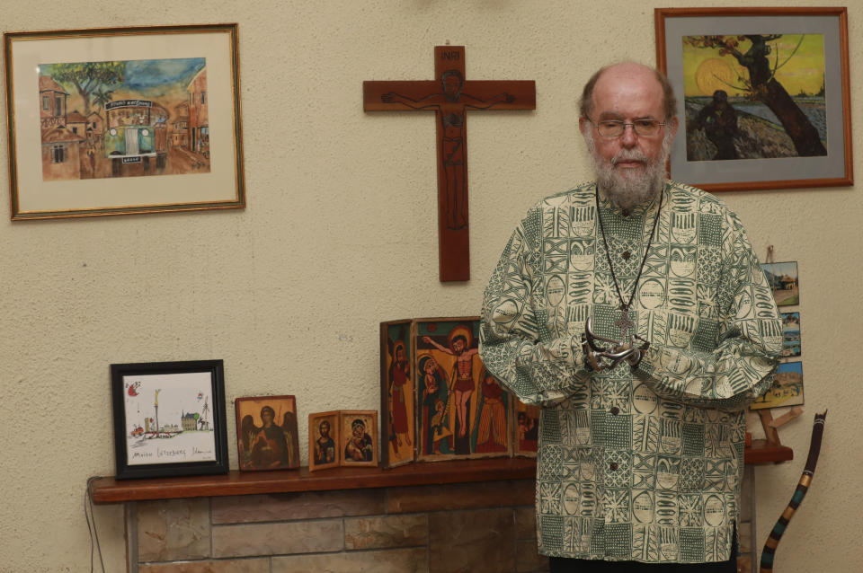 The Rev. Michael Lapsley poses for a photograph at his home in Cape Town, South Africa, Nov. 13, 2021. South Africa is engrossed in debate over the legacy of apartheid's last president, F.W. de Klerk, who died at 85 and is to be buried Sunday, Nov 21. An Anglican priest and anti-apartheid activist, Lapsley was hit by a parcel bomb that blew off his hands and blinded him in one eye in 1990, months after de Klerk freed Nelson Mandela and began negotiations that eventually dismantled apartheid. (AP Photo/Nardus Engelbrecht)