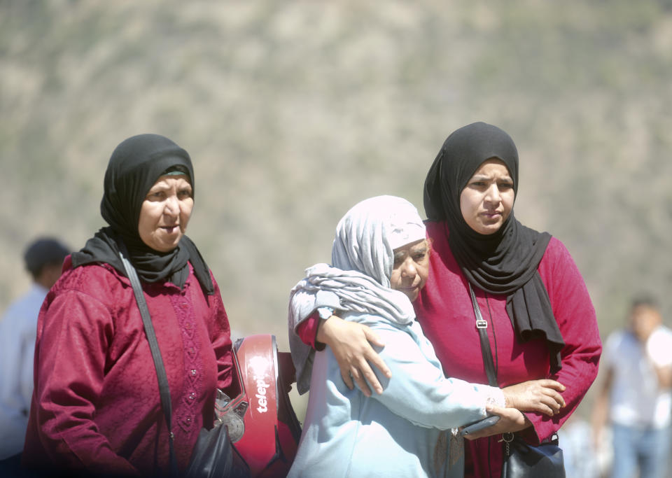 Women comfort each other after a burial for people killed by an earthquake, in Moulay Brahim village, near Marrakech, Morocco, Saturday, Sept. 9, 2023. A rare, powerful earthquake struck Morocco late Friday night, killing more than 1000 people and damaging buildings from villages in the Atlas Mountains to the historic city of Marrakech. But the full toll was not known as rescuers struggled to get through boulder-strewn roads to the remote mountain villages hit hardest. (AP Photo/Mosa'ab Elshamy)