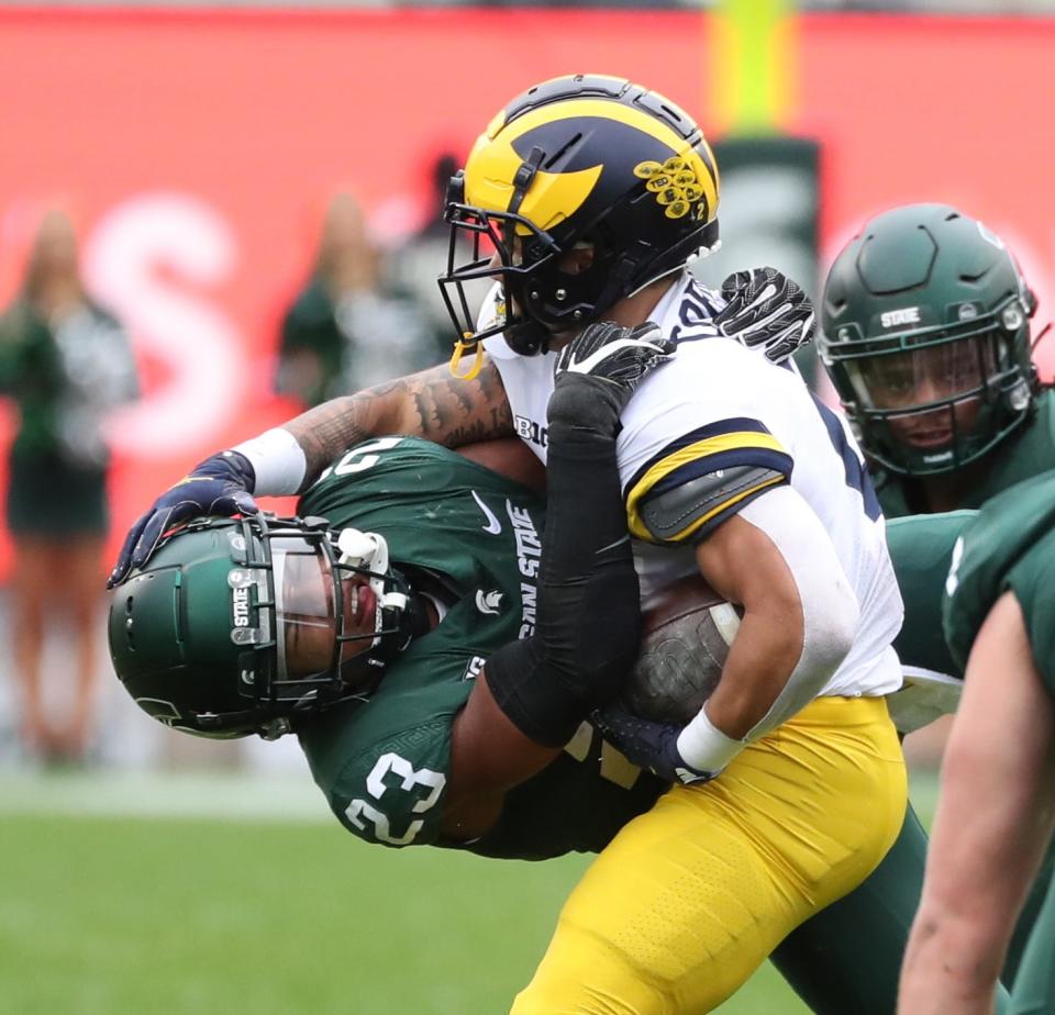 Michigan Wolverines running back Blake Corum runs against Michigan State Spartans safety Darius Snow during the first half Saturday, Oct. 30, 2021.