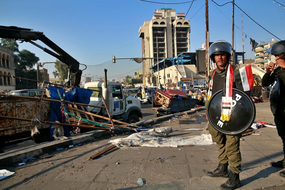 Security forces remove anti-government protesters' tents at protesters' site in Tahrir Square, Baghdad, Iraq, Saturday, Oct. 31, 2020. (AP Photo/Khalid Mohammed)