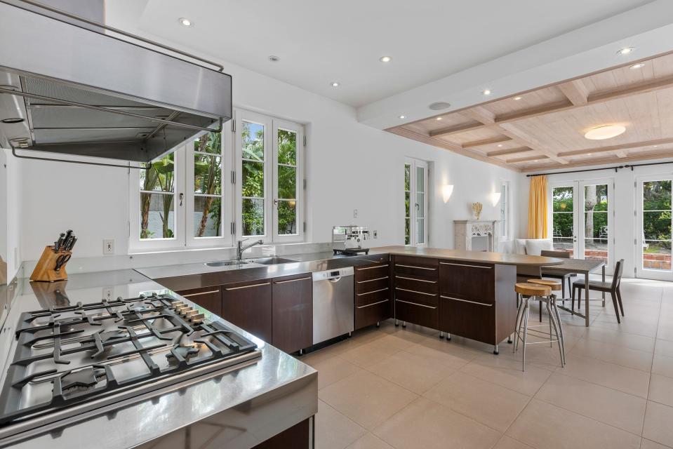 During their renovation, the Cohens combined the kitchen and dining room to create a state-of-the-art kitchen area suited for intimate gatherings and grand-scale entertaining. A contemporary-style dining table is at the far end. “We modernized (the house), but kept its character,” says Jacques Cohen.