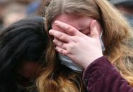 A person reacts at the site where a car crashed into pedestrians in Trier