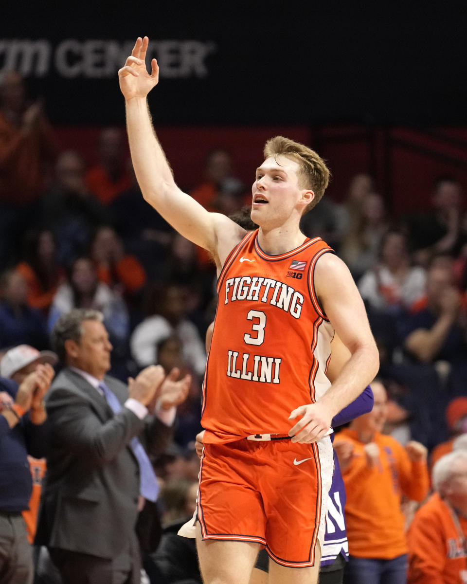 Illinois' Marcus Domask gestures to the crowd after assisting Coleman Hawkins on a dunk during the second half of an NCAA college basketball game against Northwestern Tuesday, Jan. 2, 2024, in Champaign, Ill. Illinois won 96-66. (AP Photo/Charles Rex Arbogast)
