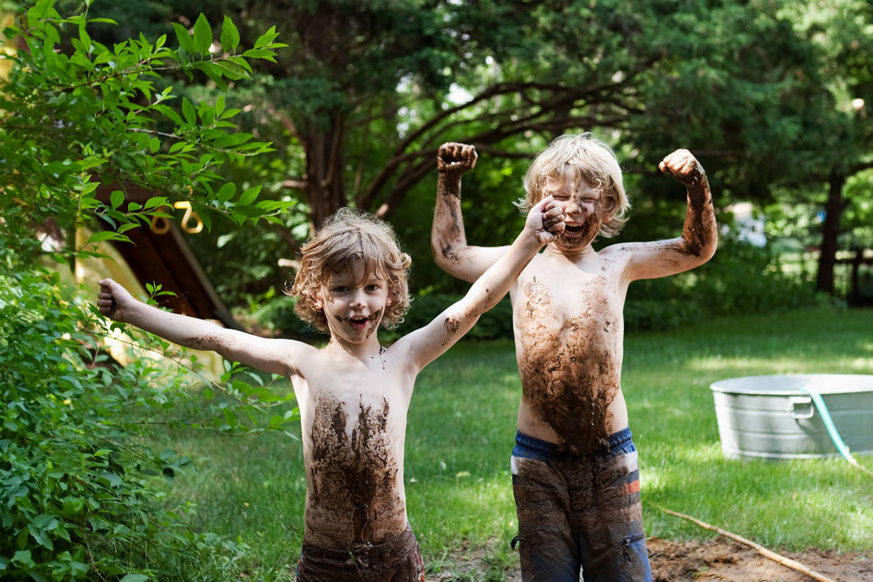 Two little boys playing in mud Getty Images/Andreas Kuehn