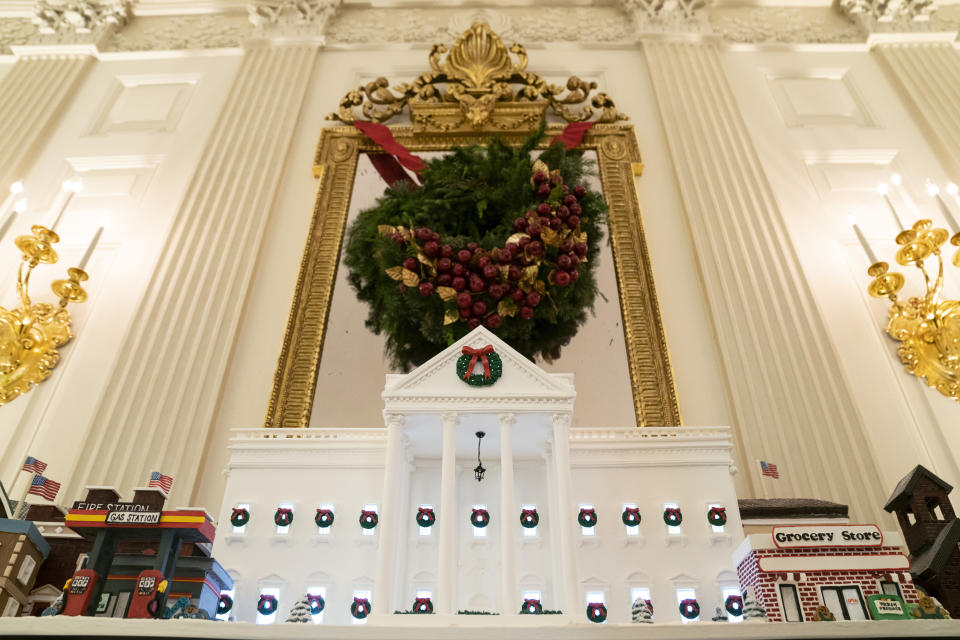 FILE - A White House gingerbread house sits in the State Dining Room during a press preview of the White House holiday decorations, Nov. 29, 2021, in Washington. In addition to fewer people passing through the White House for the open houses, thousands of other people didn't get a close-up look at how Jill Biden decked out White House hallways and public rooms for the holidays because public tours of the executive mansion remain on indefinite hold due to COVID-19. (AP Photo/Evan Vucci, File)