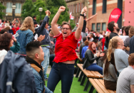 <p>An England fan in Millennium Square in Leeds leaps in delight at a goal. <br>(Picture: SWNS) </p>