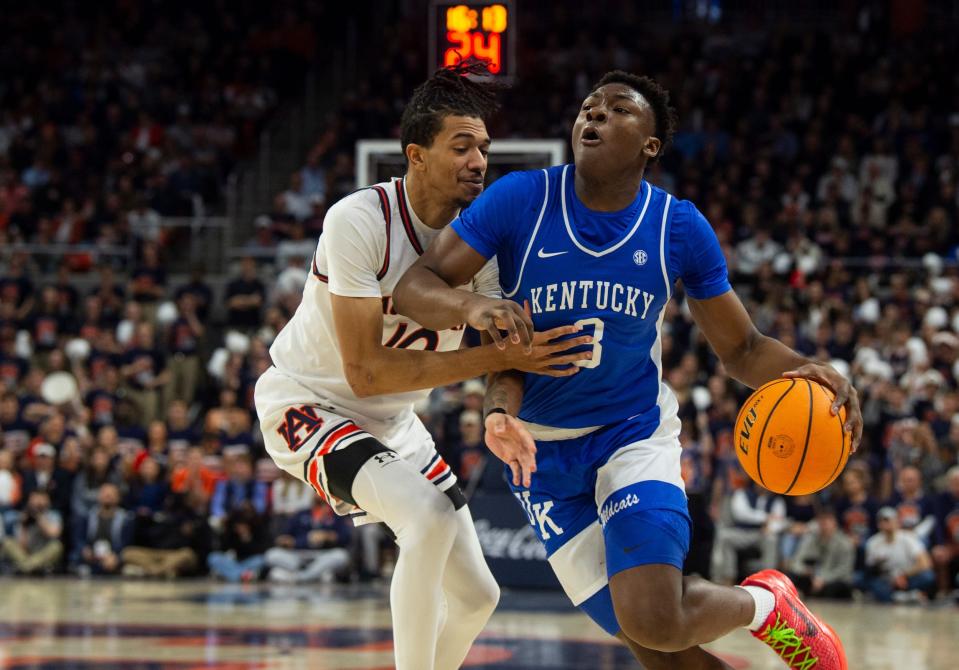 Kentucky guard Adou Thiero (3) drives the ball on Auburn forward Chad Baker-Mazara (10) during their game at Neville Arena in Auburn, Ala., on Saturday, Feb. 17, 2024.