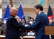 Afghanistan's President Ashraf Ghani shakes hands with U.S. Defense Secretary Mark Esper, during a news conference in Kabul