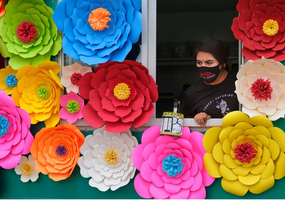 Alinne Vitales waits to take food orders at Taco-NGanas during the Cinco de Mayo celebration in 2021 at Scissortail Park.