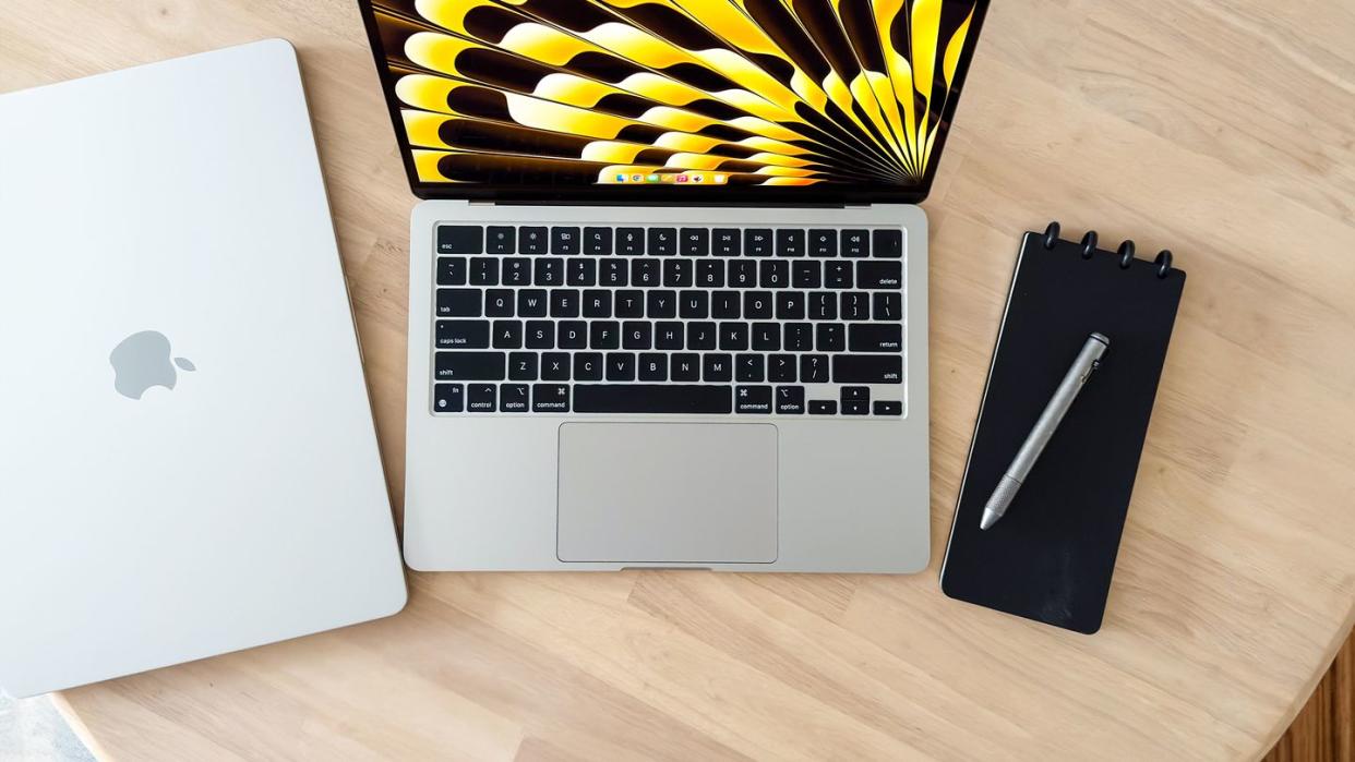 apple macbook air with m3 chip on a table with a pen and notepad