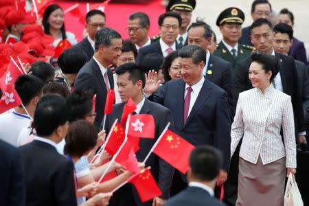 Chinese President Xi Jinping and his wife Peng Liyuan arrive at the airport in Hong Kong, China, ahead of celebrations marking the city's handover from British to Chinese rule, June 29, 2017. REUTERS/Bobby Yip