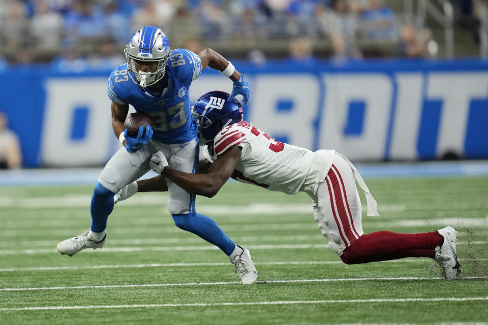 New York Giants cornerback Tre Hawkins III (37) tackles Detroit Lions wide receiver Dylan Drummond (83) during the first half of an NFL preseason football game, Friday, Aug. 11, 2023, in Detroit. (AP Photo/Paul Sancya)