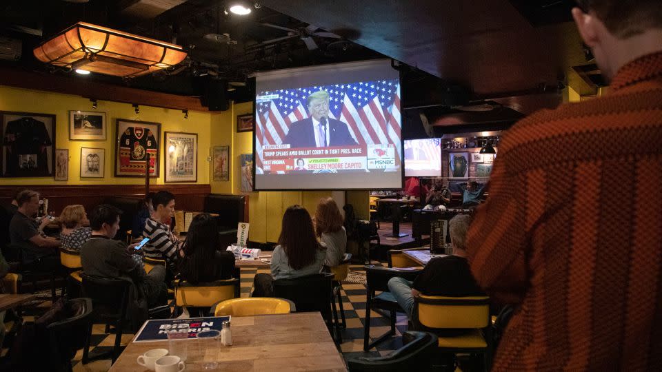 People in a Taipei bar watch former president Donald Trump speaking after he was defeated by Joe Biden in the 2020 presidential election. Four years later, both men will again go head-to-head in November's election. - Annabelle Chih/NurPhoto/AP