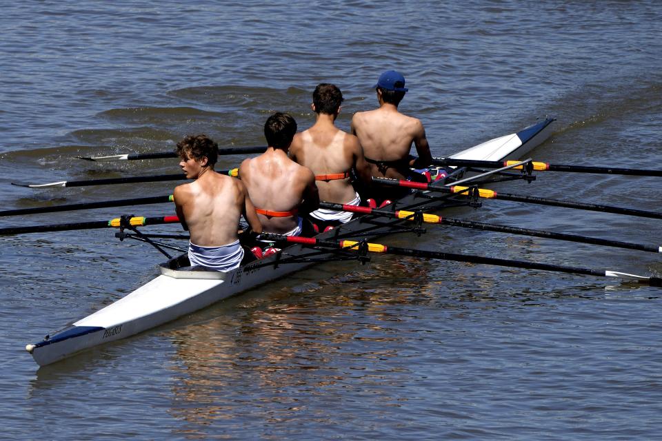 Partially suntanned rowers enjoy the sunny weather on the river Thames near Hammersmith in London, Friday, July 15, 2022. British weather forecaster the Met Office has said temperatures are like to peak at the beginning of next week and has extended its Amber weather warning from Sunday to Tuesday.(AP Photo/Frank Augstein)