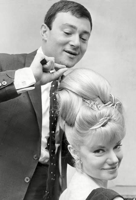 <b>A busy bee</b> <br><br> Vidal Sassoon adds the finishing touches to singer Miss Denney Dayviss' beehive hairdo in preparation for The Dorchester Ball. Though Vidal didn't invent the style, it was a popular coif in the '60s and involved extensively backcombing the hair and then smoothing the top for a big, piled-high look.