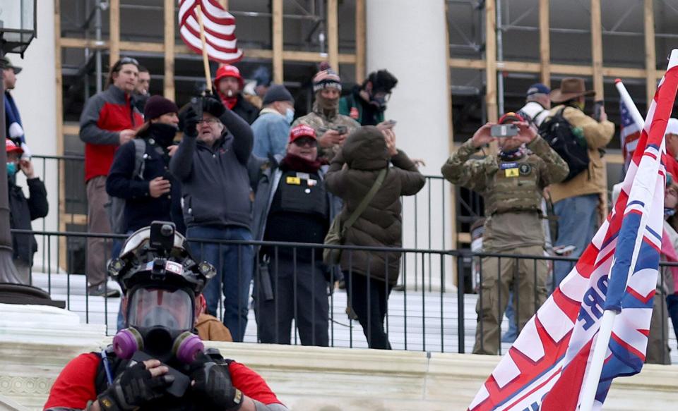 Russ Taylor (middle, in MAGA hat) on the west side of the Capitol during the attack. Another likely defendant, wearing a similar patch, appears on the right. (Photo: Tasos Katopodis via Getty Images)