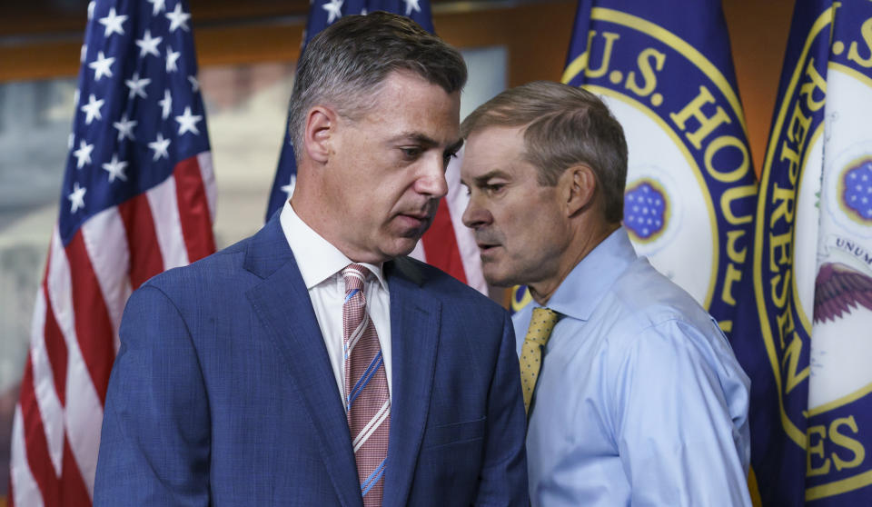 Rep. Jim Banks, R-Ind., left, and Rep. Jim Jordan, R-Ohio, exchange places at the podium during a news conference on Capitol Hill Wednesday. (AP Photo/J. Scott Applewhite)